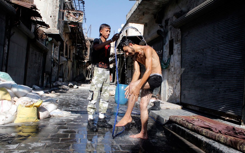 A Free Syrian Army fighter takes a shower in Aleppo. (Reuters/Molhem Barakat)
