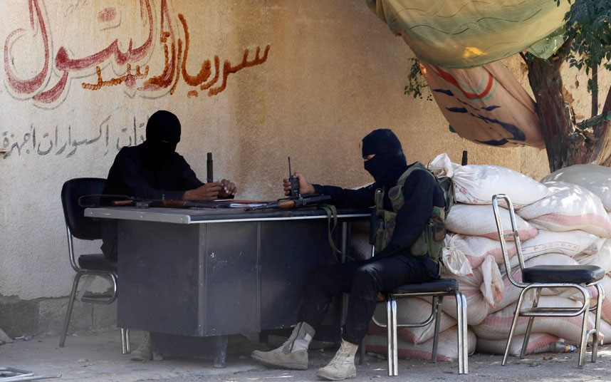 Free Syrian Army fighters sit at their guard post in eastern Hama. (Reuters/Molhem Barakat)
