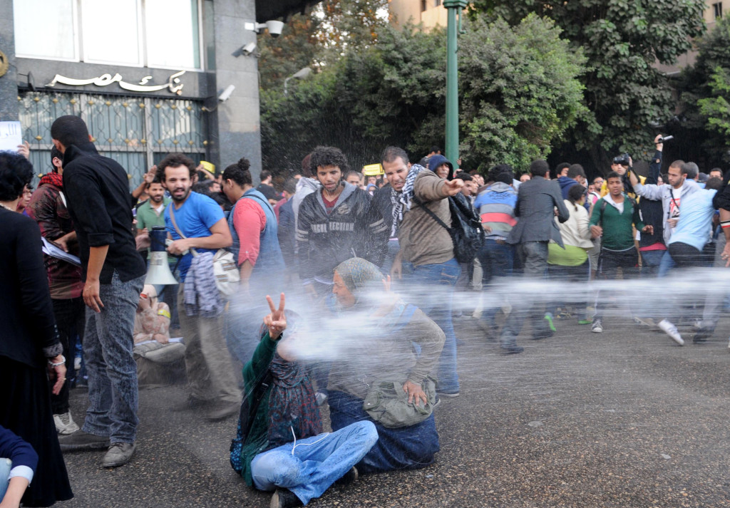 Egyptian police fire water cannons to disperse a protest by secular anti-government activists in Cairo on Nov. 26, 2013, the security forces' first implementation of a controversial new law forbidding protests held without a permit from authorities.