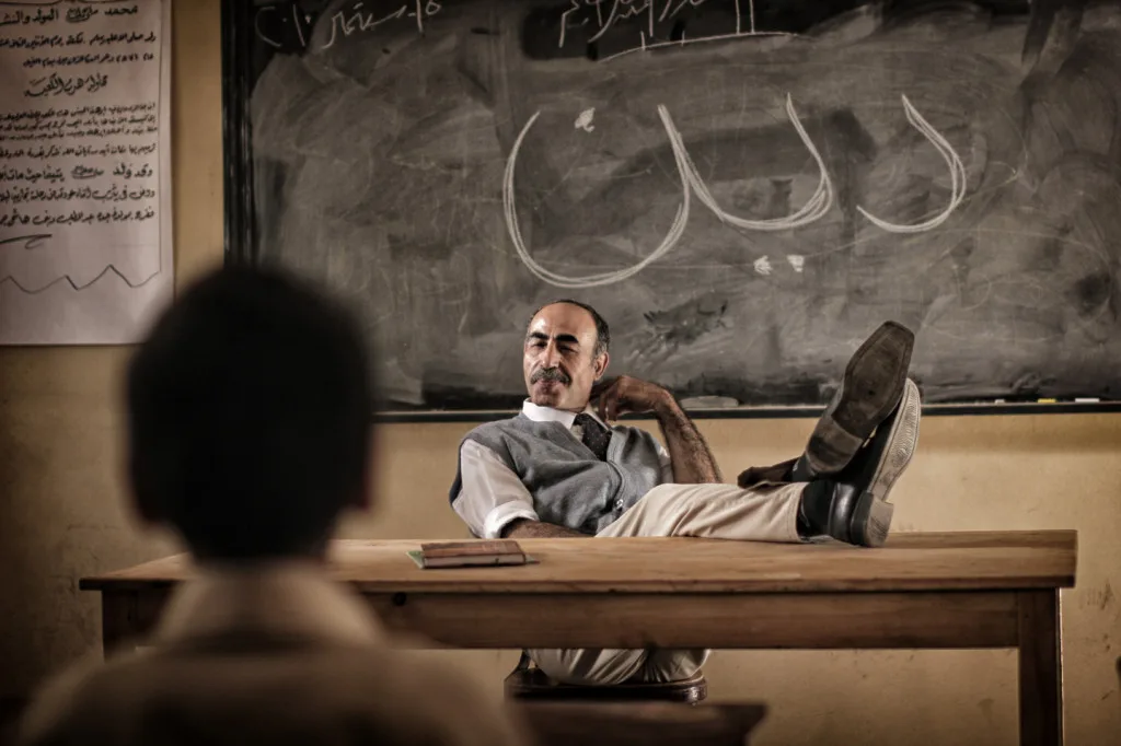A shot from a religion class at the school. The word "religion" is written on the blackboard. Courtesy of Aly El Banna.