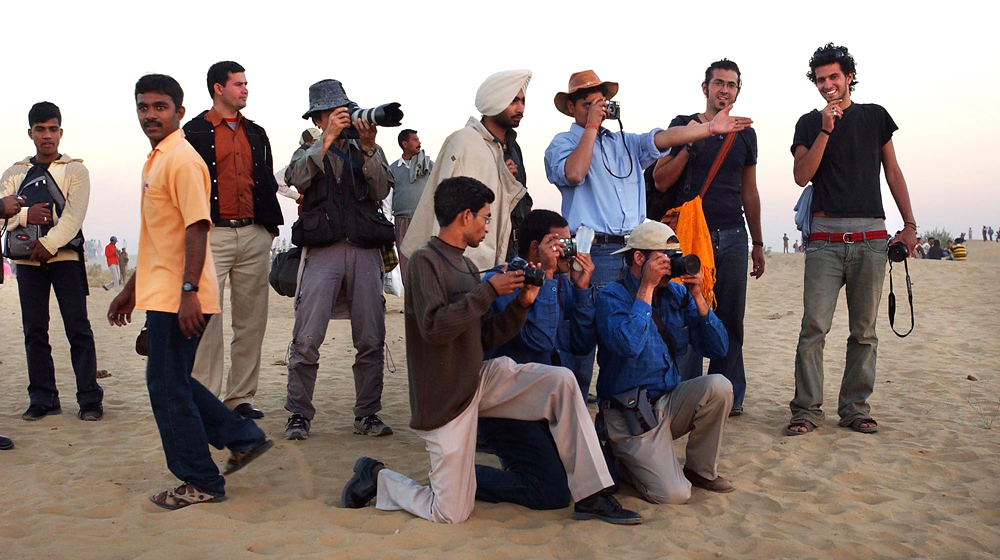 Image:  Tourists with cameras gather
