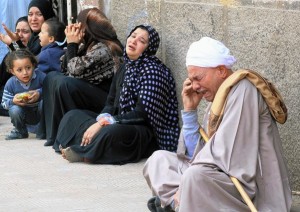 Relatives of MB supporters sentenced to death, sitting outside the courtroom in Minya after the court announced the mass death sentence (AFP/Getty Images)