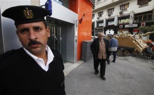 An Egyptian policeman stands guard outside a bank in Cairo