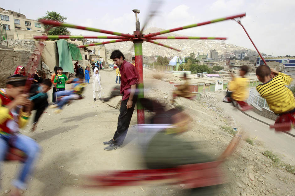 Children playing on carnival rides in Kabul, Afghanistan