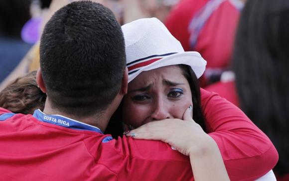 Costa Rica fans react after their team lost to Netherlands, during 2014 World Cup quarter-finals soccer match at Democracia square in San Jose