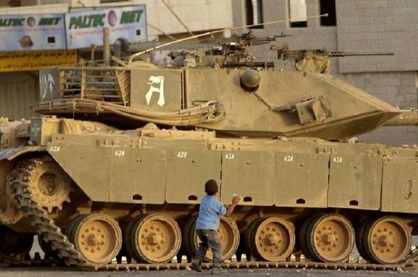 boy in front of tank