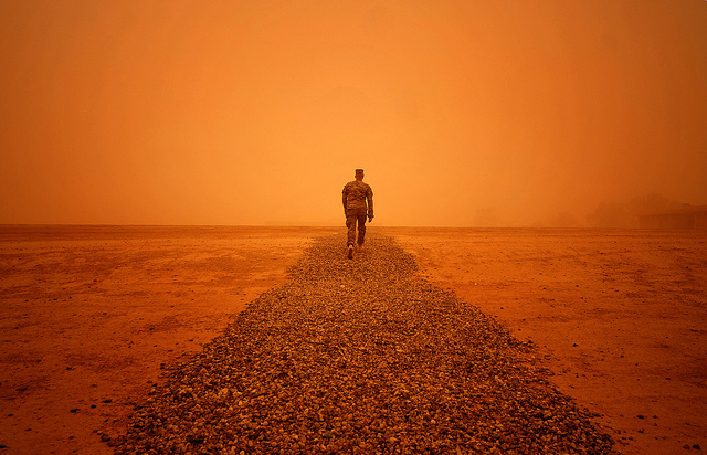 Sgt. 1st Class Justin Hathaway, United States Forces-Iraq Provost Marshal Office operations non-commissioned officer in charge, braves a sandstorm after leaving the 9th Air and Space Expeditionary Task Force-Iraq and U.S. Forces-Iraq Provost Marshal Office at Al Asad Air Base, Iraq, Sept. 27, 2011.