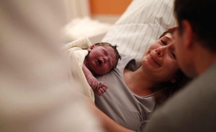 Newborn Stefan Alexander Heinrich rests with mother Sabine Heinrich in a delivery room of Fuerstenfeldbruck hospital, southern Germany, January 12, 2013. Stefan was born at 3:47 on January 12, 2013, with a weight of 3790 grammes and a size of 53 centimetres.    REUTERS/Michaela Rehle (GERMANY - Tags: HEALTH SOCIETY) - RTR3CVSP