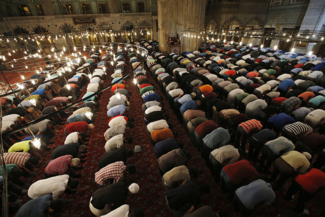 Muslims pray in the iconic Sultan Ahmed Mosque, better known as the Blue Mosque, in the historic Sultanahmet district of Istanbul, Turkey, late Wednesday, June 17, 2015, during the first 'taraweeh', nightly prayer of the month of Ramadan. Millions of Muslims around the world will mark the start of Ramadan on Thursday June 18, a month of intense prayer, dawn-to-dusk fasting and nightly feasts. Muslims follow a lunar calendar and a moon-sighting methodology that can lead to different countries declaring the start of Ramadan a day or two apart. (AP Photo/Emrah Gurel)