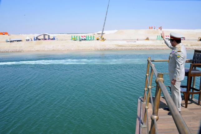 Egyptian President Abdel Fattah al-Sisi stands on a boat on the Suez Canal as he attends the celebration of an extension of the Suez Canal in Ismailia (Egyptian Presidency/Handout)