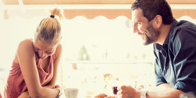 Young couple has breakfast at italian café