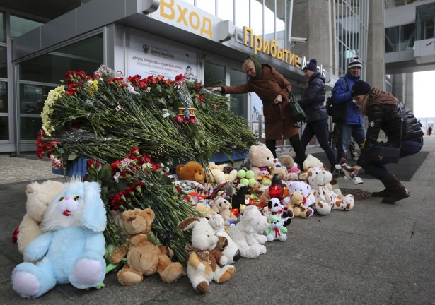 People lay toys and flowers outside Pulkovo airport in St. Petersburg for the victims of the Russian airplane crash in Egypt. (Peter Kovalev/Reuters)