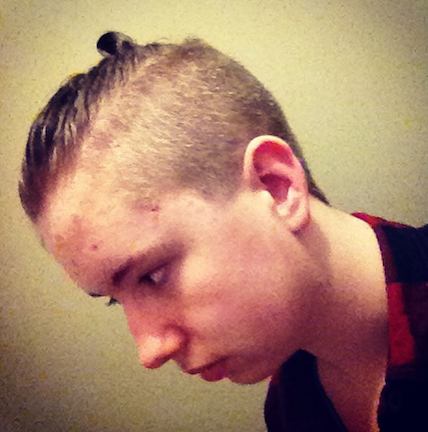 A-young-man-with-a-top-knot-undercut-hairstyle