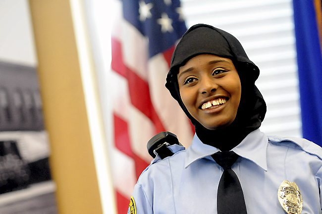 St. Paul Community Officer Kadra Mohamed smiles after receiving her badge from St. Paul Police Chief Tom Smith on Saturday, March 1, 2014, during a ceremony for her and the East African Junior Police Academy at theWestern District Police Station in St. Paul. The police department introduced the hijab headscarf during the ceremony and Mohamed is the first officer in Minnesota to wear one.(Pioneer Press: Sherri LaRose-Chiglo)