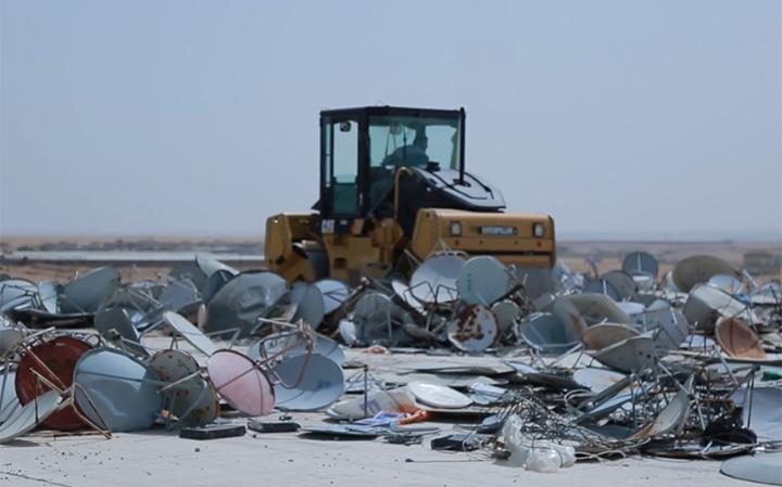 A screenshot from Daesh's most recent video urging satellite dishes to be destroyed.