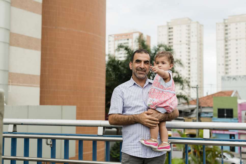 Khaled Dacka holding 18-months-old Yara. Via UNHCR.