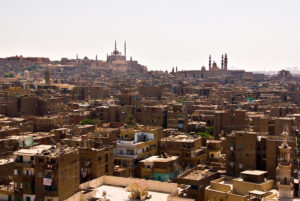 Cairo, Egypt -- View from the minarets of the Bab Zuwayla gate. One of the three first gates installed around the historic walled city of Cairo, standing at the southern boundary of old Fatimid Cairo. The two minarets atop this tower actually belong to the nearby Mosque of al-Mu'ayyad, which sits just inside this gate. For a small fee, it is possible to climb the minarets for a spectacular view of old and new Cairo. The Citadel of Saladin (on the left) and the Mosque and madrassa of Sultan Hassan (on the right) dominate the skyline of the city in this direction. © Rick Collier / RickCollier.com. travel; vacation; tour; tourism; tourist; destination; Egypt; Cairo; city; view; gate; walls; bab; "Bab Zuwayla"; Zuwayla; minaret; Fatimid; Fatmid; "city gate"; "Islamic Cairo"; mosque; madrassa; citadel; Saladin; Hassan; "Sultan Hassan"; "Citadel of Saladin"