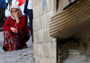 A woman pauses as she sits near the scene of an explosion where a suspected suicide bomber targeted a wedding celebration in the Turkish city of Gaziantep, Turkey, August 21, 2016. REUTERS/Osman Orsal