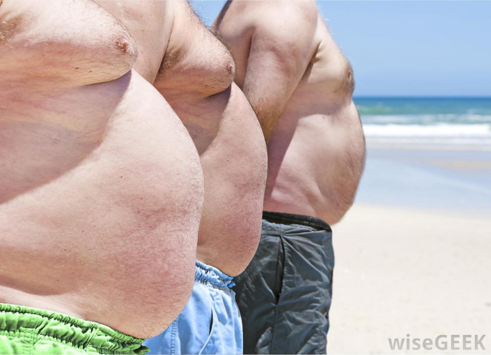 three-men-with-beer-bellies-at-the-beach