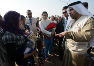 Rashid al-Mansuri, Consul General of the United Arab Emirates to Arbil, visits Syrian-Kurdish refugees as aid is distributed by the Emirates Red Crescent at the Quru Gusik (Kawergosk) refugee camp, 20 kilometres east of Arbil, the capital of the autonomous Kurdish region of northern Iraq, on January 4, 2014. Rebels battling jihadists in northern Syria have killed or captured scores of the militants loyal to an Al-Qaeda affiliate in two days of fighting, a watchdog said. AFP PHOTO/SAFIN HAMED