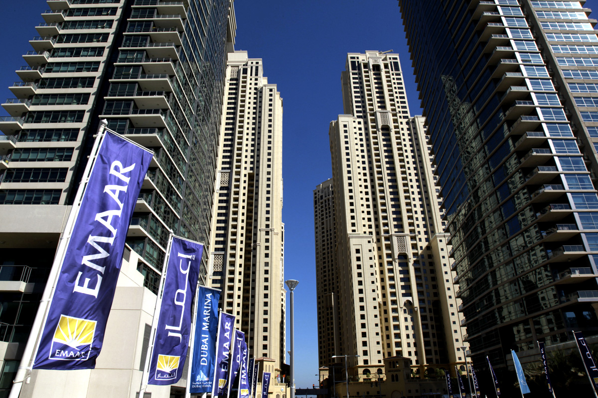 Flags of Emaar Properties PJSC, builder of the world's tallest skyscraper, fly near high-rise properties in the Marina district of Dubai, United Arab Emirates, on Saturday, Dec. 10, 2011. Dubai and its state-owned non-financial companies have $101.5 billion of outstanding debt and may need further financial support to meet those obligations, Moody's said. Photographer: Gabriela Maj/Bloomberg