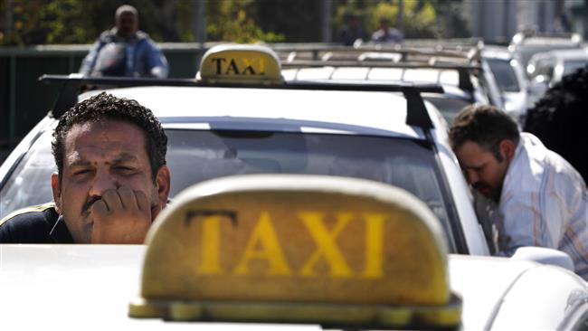 This photo shows an Egyptian taxi driver peering over his car while stuck in traffic. Via AP