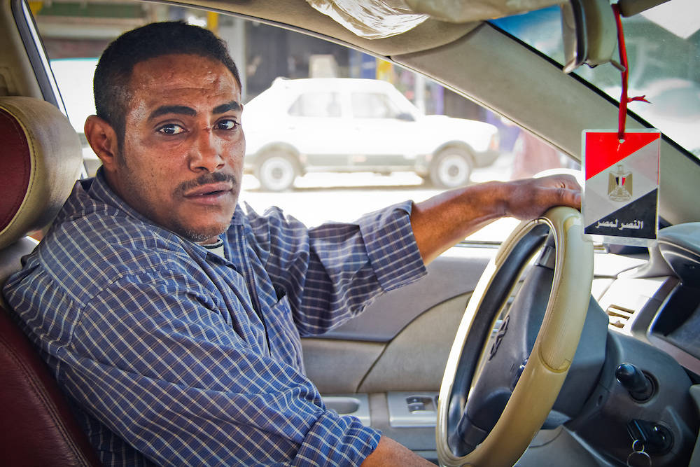 Egyptian taxi driver Sayed Attiya at the wheel of his vehicle in Cairo's district of Imbaba. Via Robin Wyatt